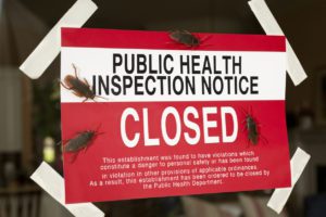 Sign on door of public health inspection closure with cockroaches present
