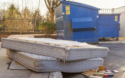 Old Mattresses Discarded near Blue Dumpsters